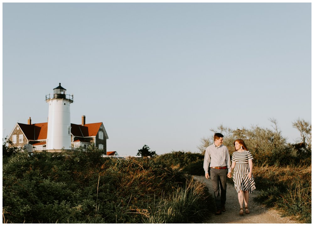 couple walking by lighthouse