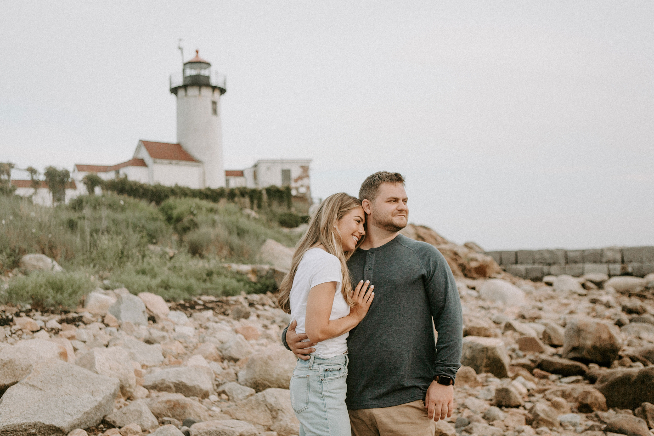 couple standing in front of lighthouse